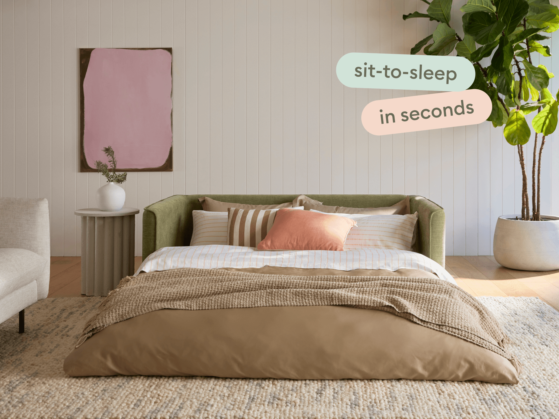Luxurious green sofa bed with a textured fabric finish, effortlessly converting to a plush, inviting bed. Styled in a modern living room with neutral tones.