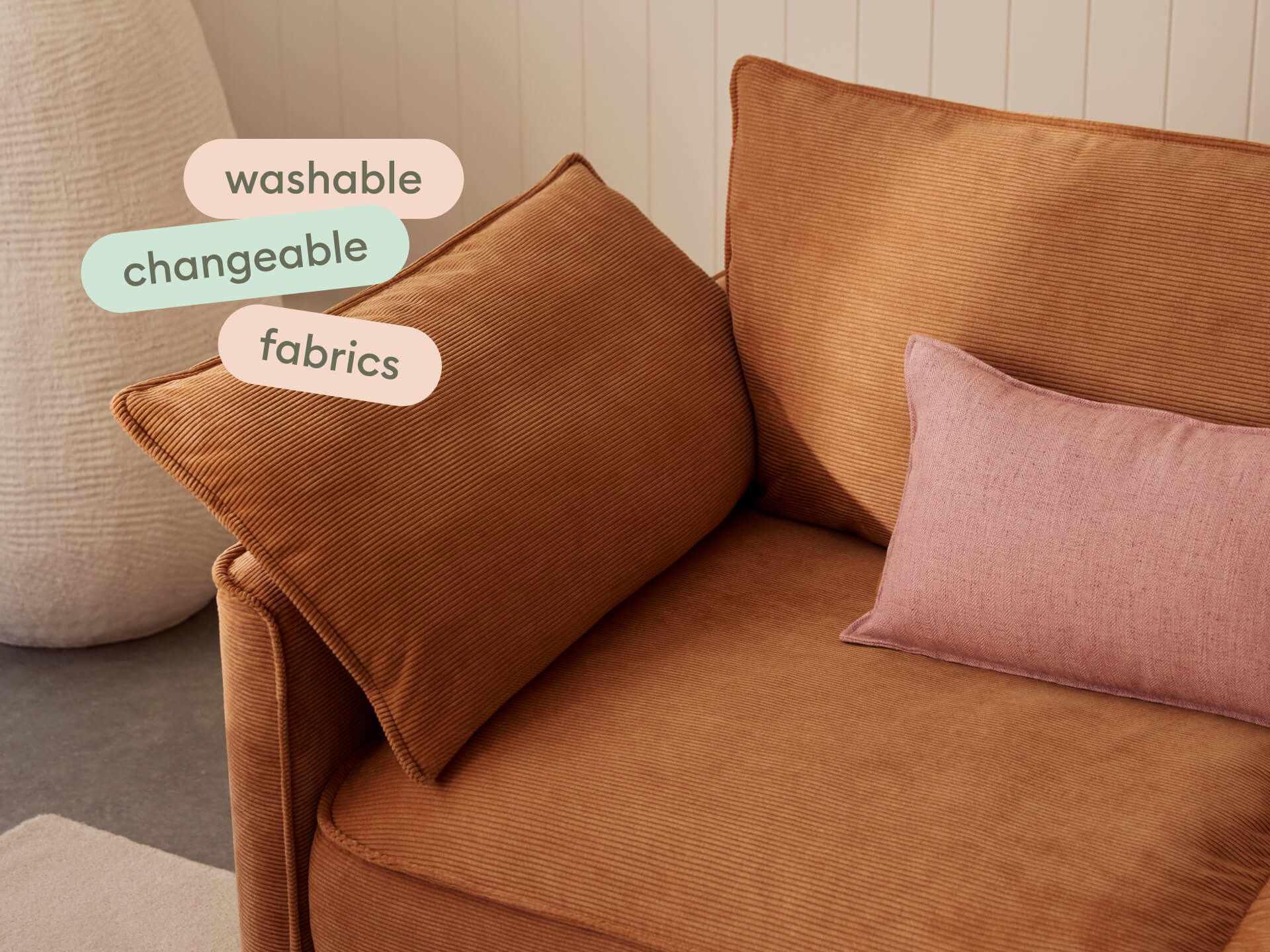 Koala Sofa Bed Double in terracotta corduroy close-up with washable changeable fabrics text overlay