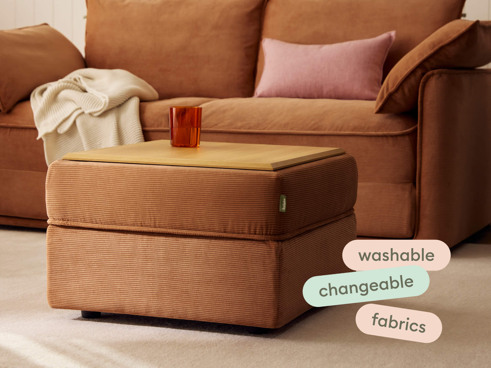 Koala Sofa Bed Ottoman in terracotta corduroy close-up detail with pink cushion in styled setting