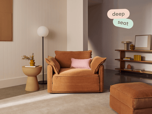 Koala Sofa Bed Single in terracotta corduroy in styled living room with glass coffee table and cushions