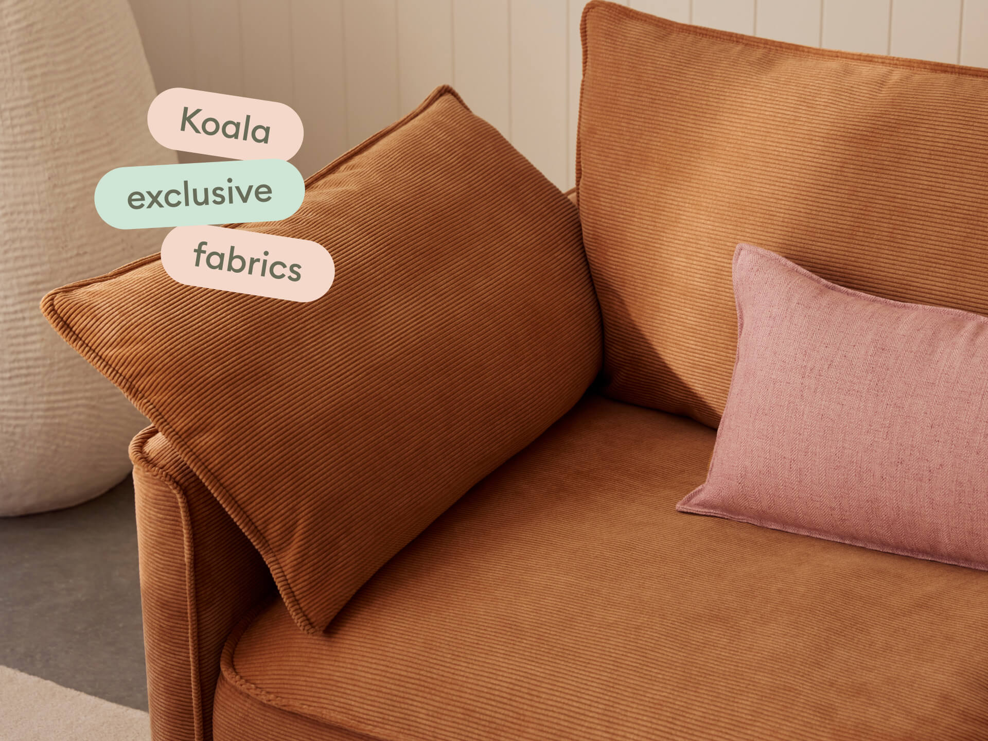 Koala Sofa Bed Single in terracotta corduroy close-up with Koala exclusive fabrics text overlay