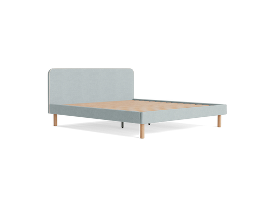 Light grey upholstered bed frame with a minimalist design, light wooden legs, and a slatted base. No mattress included.