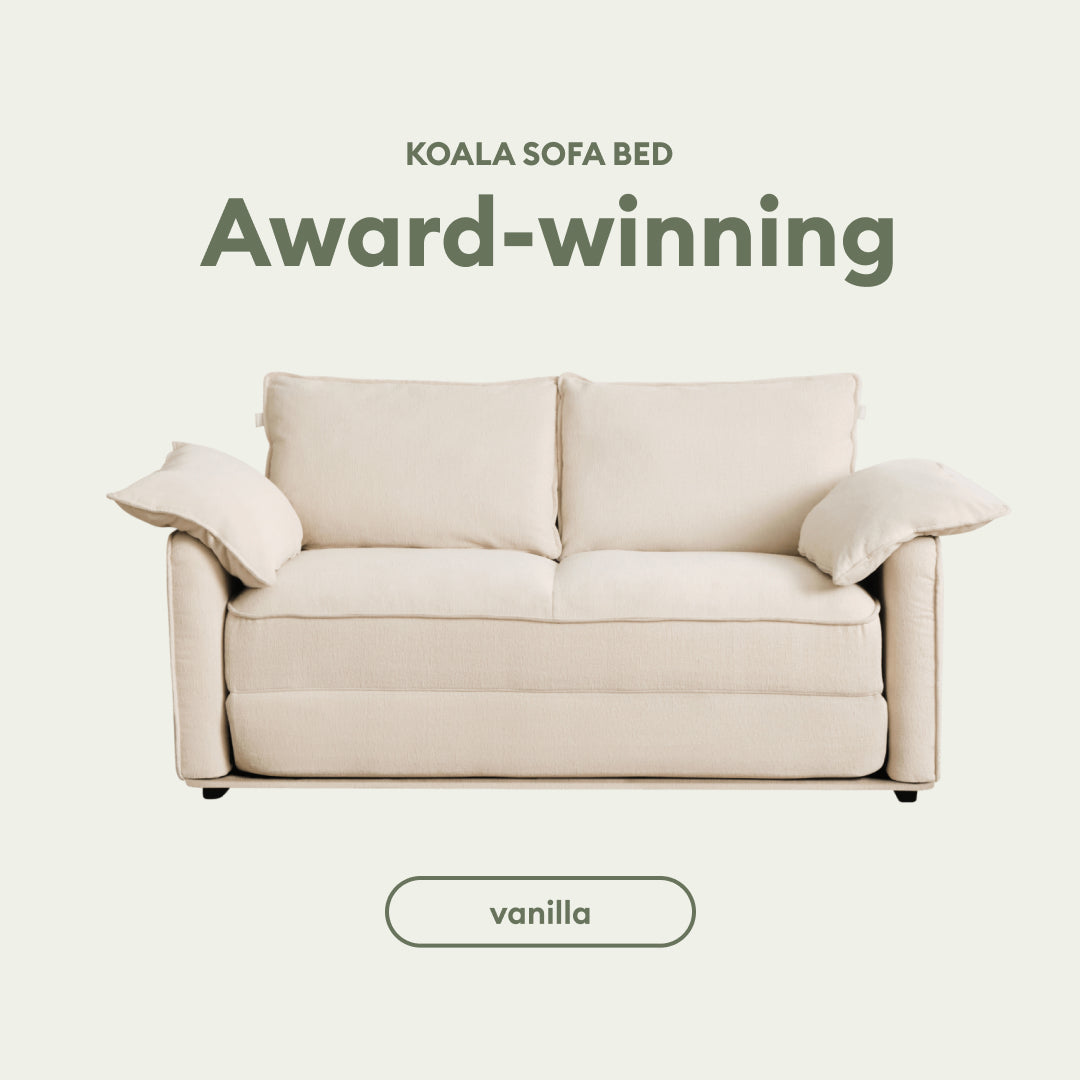 A vanilla-colored sofa bed with plush cushions, displayed against a soft green background, labeled “Award-winning.”