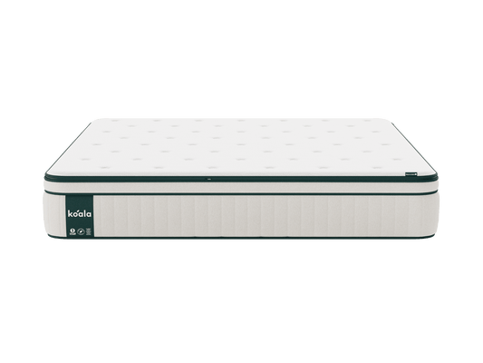 White mattress with black trim, displaying a subtle pattern. Features a visible brand label on the side.