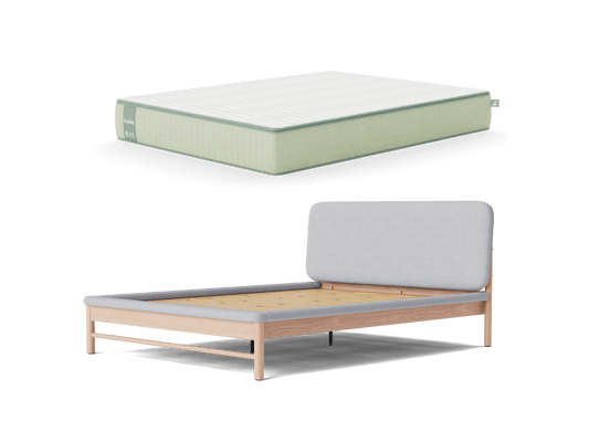 Light green mattress next to a wooden bed frame with a light grey upholstered headboard. Furniture for bedroom decor.