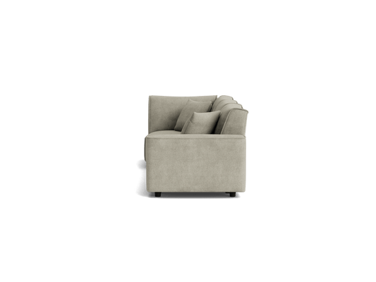 Side view of a light grey, modern, boxy sofa with cushions, displaying a minimalist design. Perfect for contemporary living spaces.