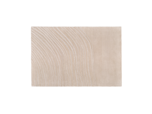 Beige area rug with subtle curved line pattern design on one side.