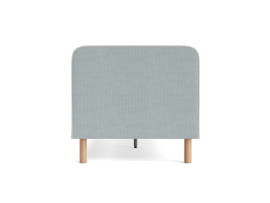 Light grey upholstered headboard with rounded top edges, supported by two wooden legs.