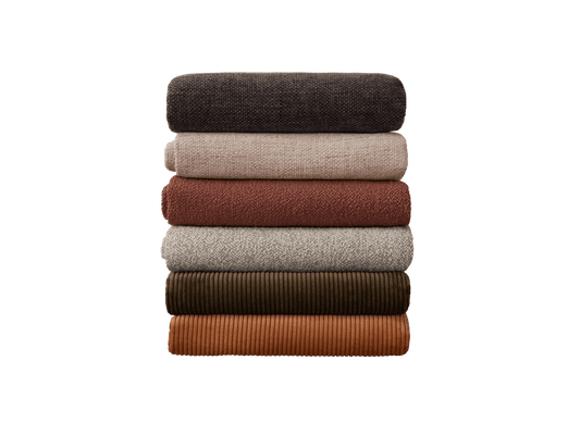 Stack of six folded fabrics in dark grey, light brown, rust, beige, olive green, and orange, arranged vertically on a white background.