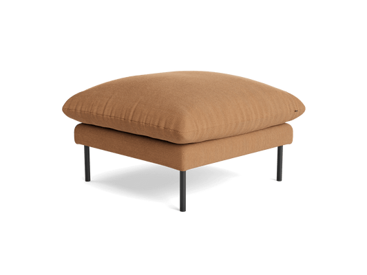 Tan ottoman with a plush cushion on sleek black metal legs. Modern and minimalist design. Perfect for living room or lounge area.