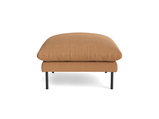 Brown upholstered ottoman with plush cushion and sleek black metal legs, casting a slight shadow on the ground.