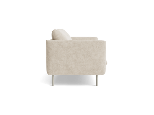 Side view of a beige fabric armchair with a cushion, supported by thin metal legs, on a white background. Modern minimalist furniture design.