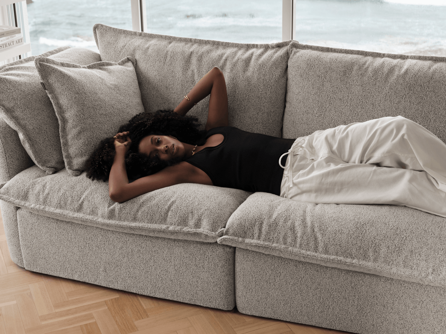 Koala Tamarama 5-section L-shape sectional in Aussie Latte, with terracotta velvet cushion and city view