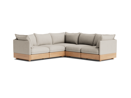 Light grey L-shaped sectional sofa with plush cushions and light wood base. Ideal for modern living room decor.