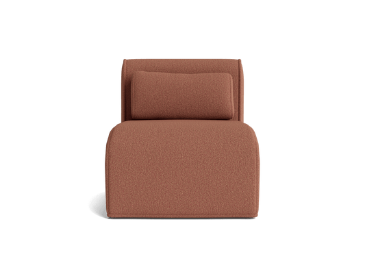 Rust-coloured upholstered lounge chair with a rectangular back cushion and rounded edges, set against a plain background.