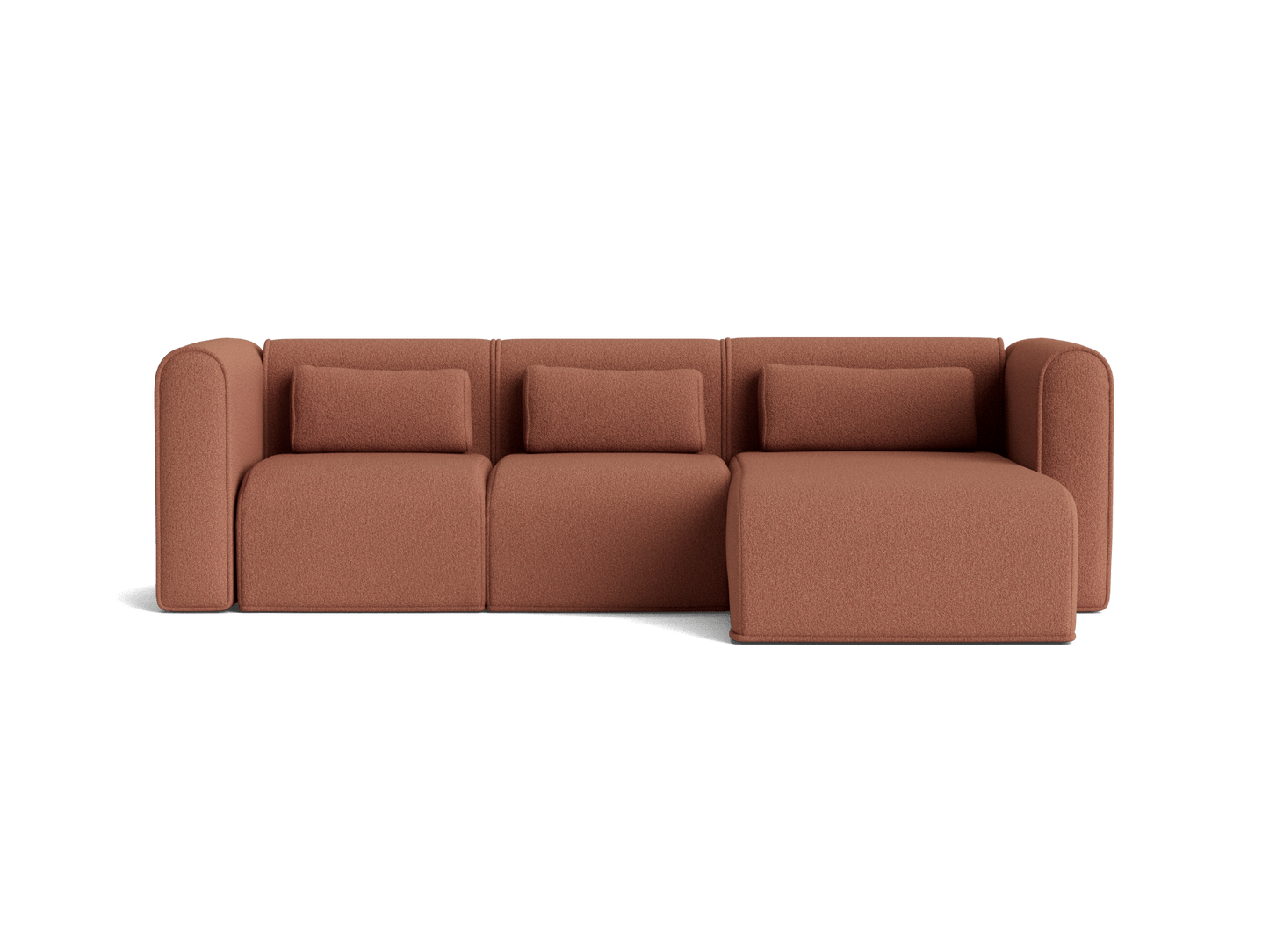 Rust-coloured sectional sofa with three cushions and a chaise lounge on the right. Modern and sleek design.