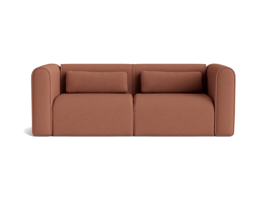 Rust brown sofa with curved armrests, two seat cushions, and two rectangular back cushions. Modern, minimalist design on a white background.