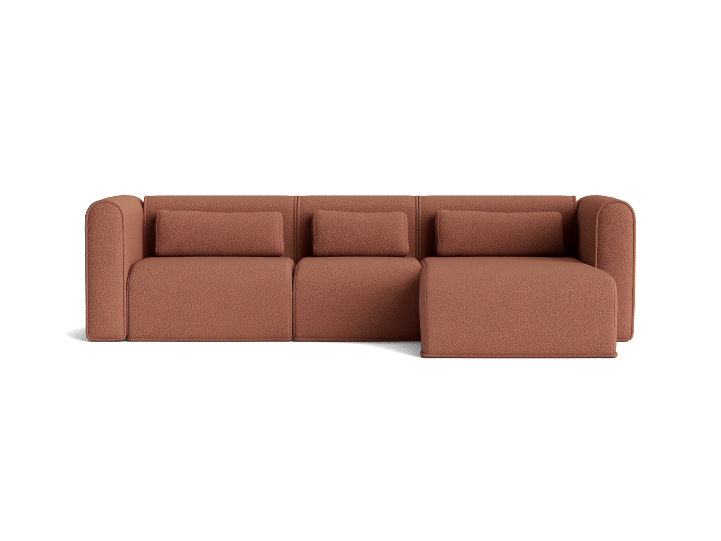 Rust brown modular sofa with three seats and chaise lounge. Upholstered fabric features rounded armrests and matching back cushions.