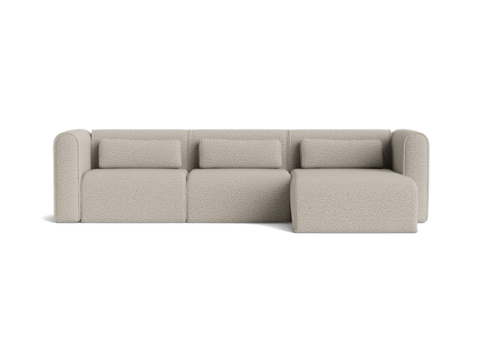 Light grey, modern sectional sofa with three cushions and a chaise lounge on the right side. Stylish, minimalist design.