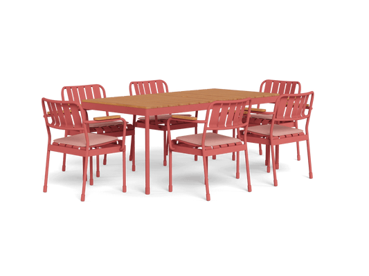 Outdoor dining set with a wooden table and six pink metal chairs featuring slatted backs and white cushions.