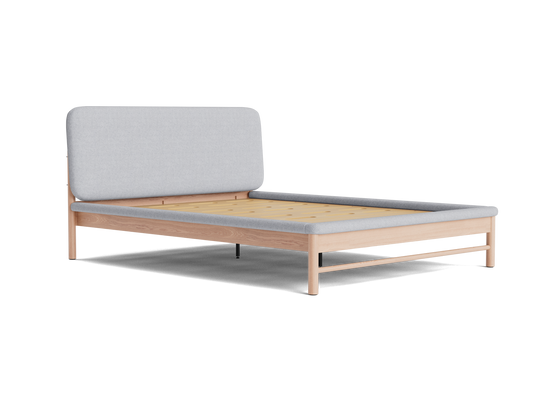 Minimalist wooden bed frame with light grey fabric headboard. Natural wood finish slats, modern design. Ideal for contemporary bedrooms.